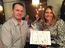 Евгений и Ольга позируют шаржисту Мишелю